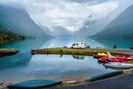 Family vacation in an RV, parked near a mountain lake